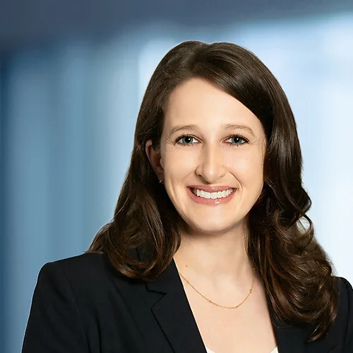A photo of attorney Ashleigh Kasper against a softly blurred office background