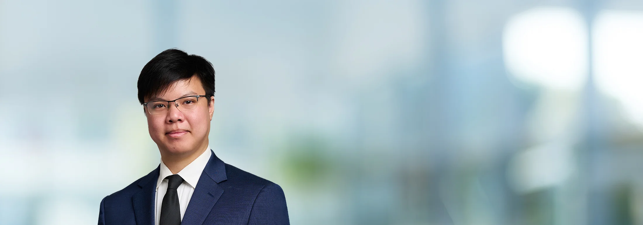 A photo of attorney Patrick Lee against a softly blurred office background