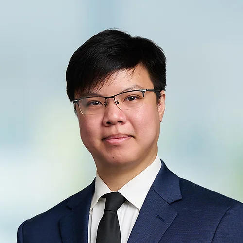 A photo of attorney Patrick Lee against a softly blurred office background