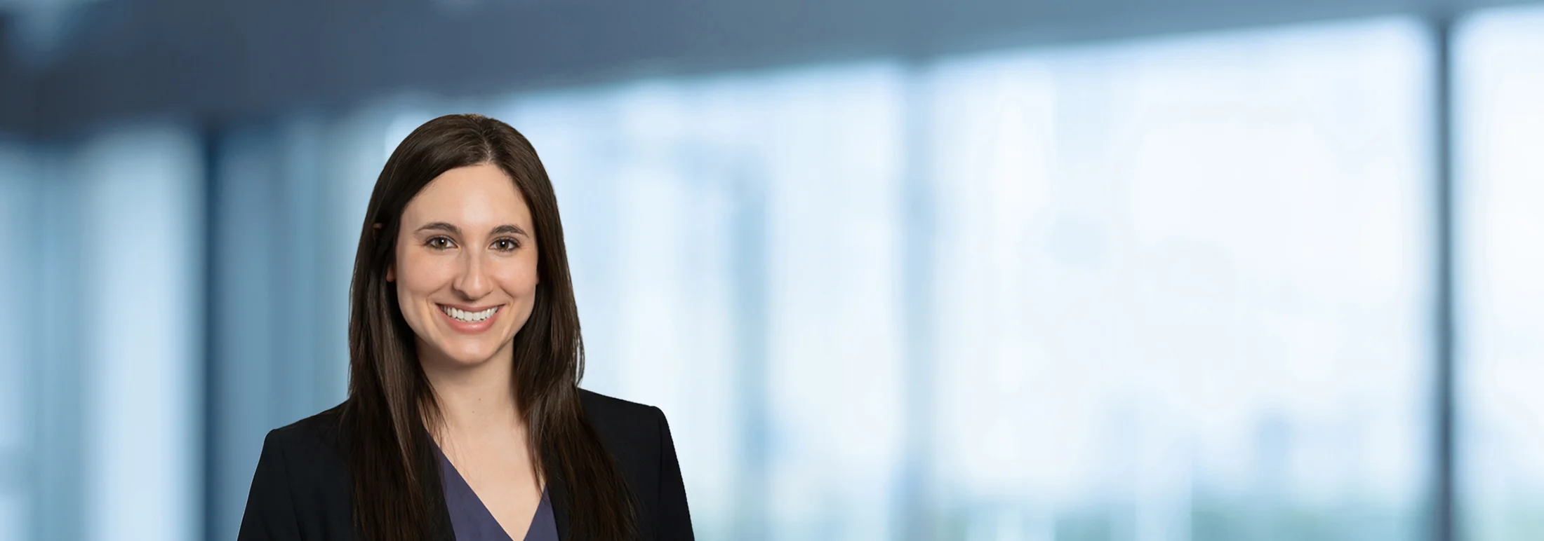 A photo of attorney Kerri Lutfey against a softly blurred office background
