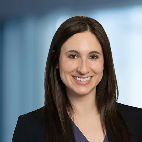 A photo of attorney Kerri Lutfey against a softly blurred office background