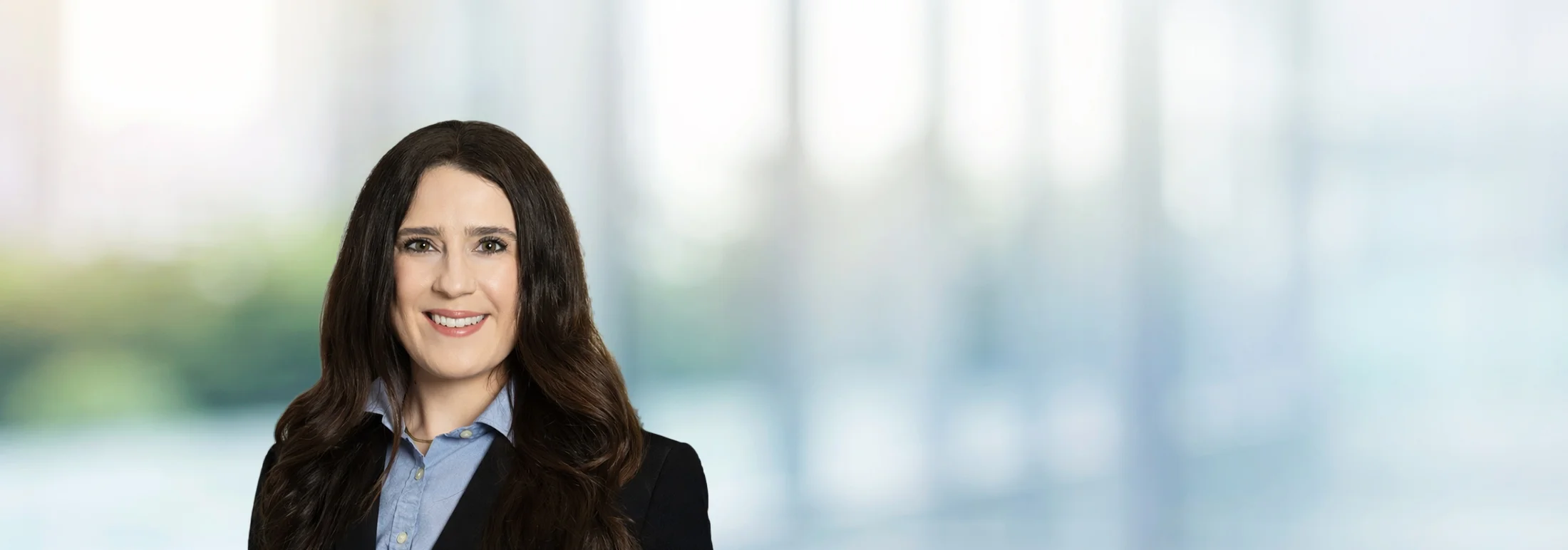 A photo of attorney Elizabeth Martin against a softly blurred office background