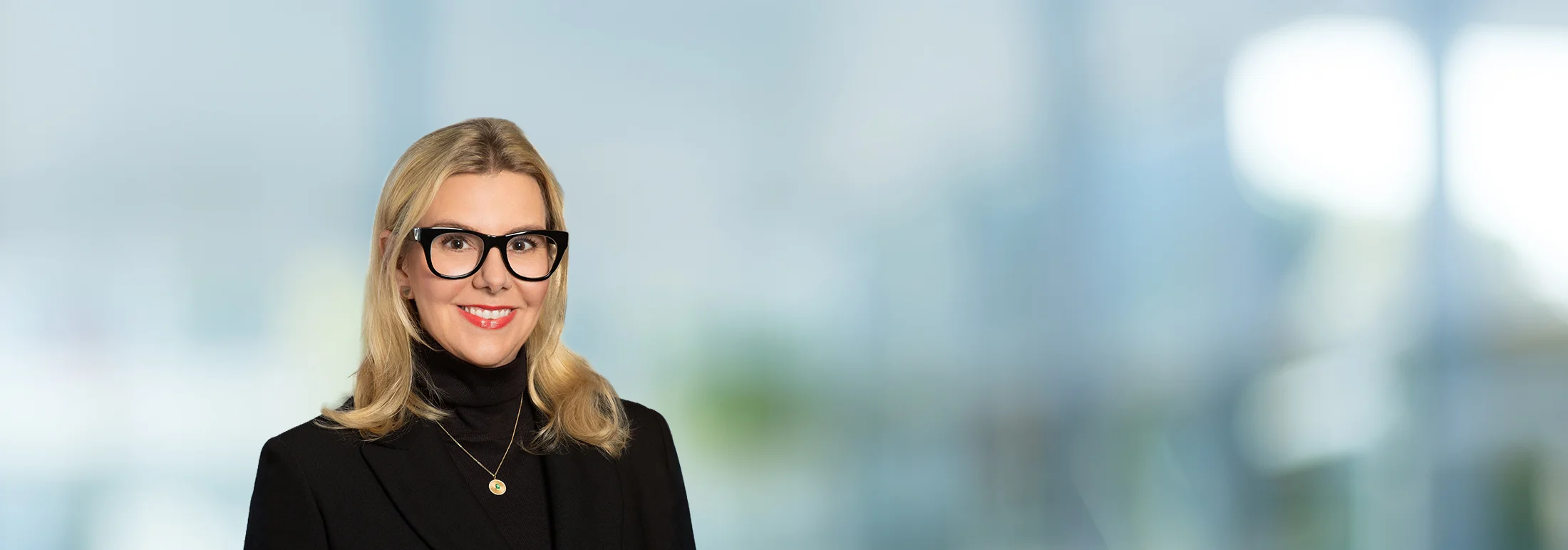 A photo of attorney Meghan McCord against a softly blurred office background