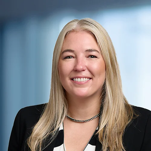 A photo of attorney Meghan McNally against a softly blurred office background