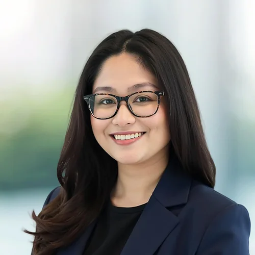 A photo of attorney Iya Merilles against a softly blurred office background