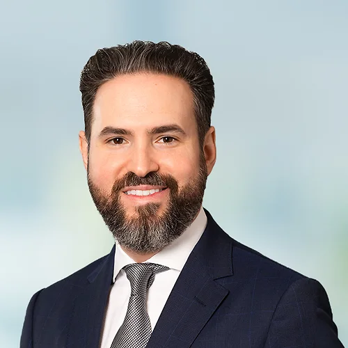 A photo of attorney Krikor Moloyan against a softly blurred office background