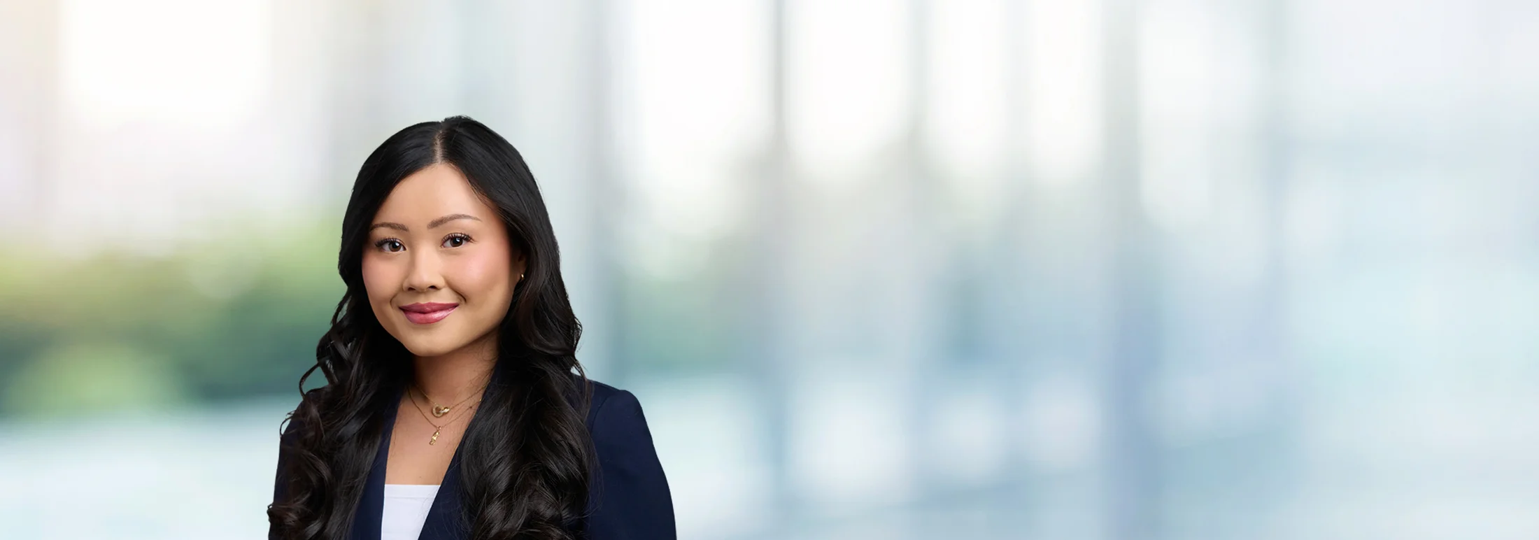 A photo of attorney Tiffany Nguyen against a softly blurred office background