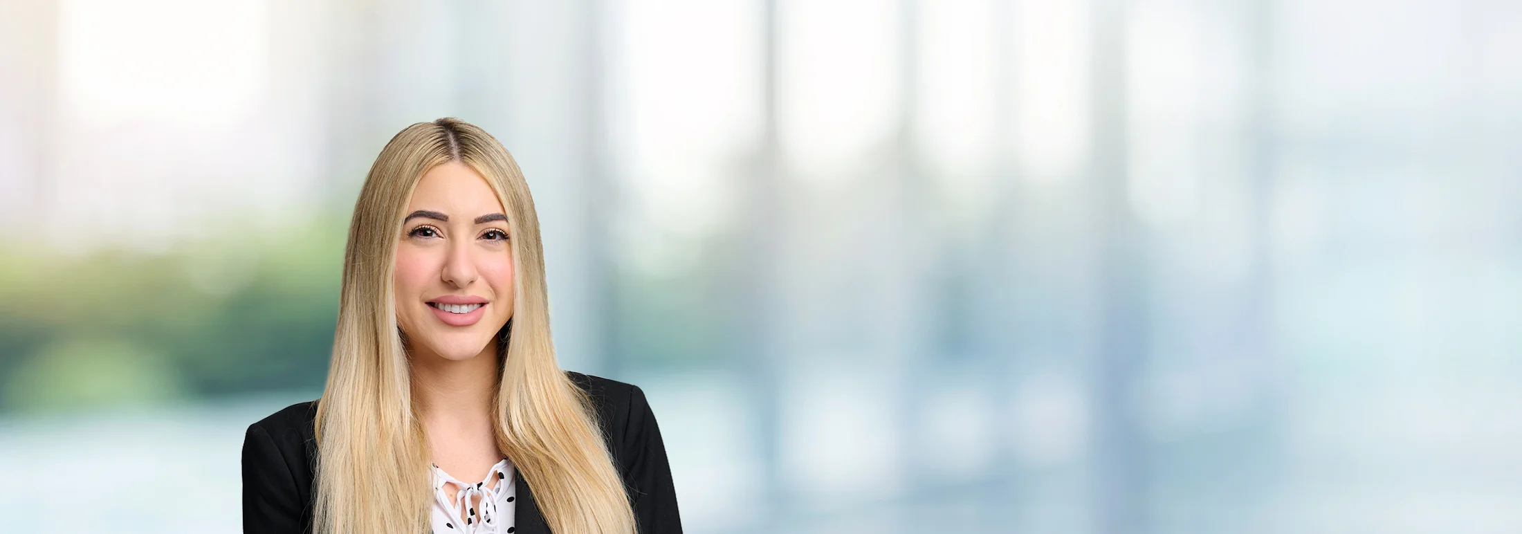 A photo of attorney Jasmine Ramezanzadeh against a softly blurred office background
