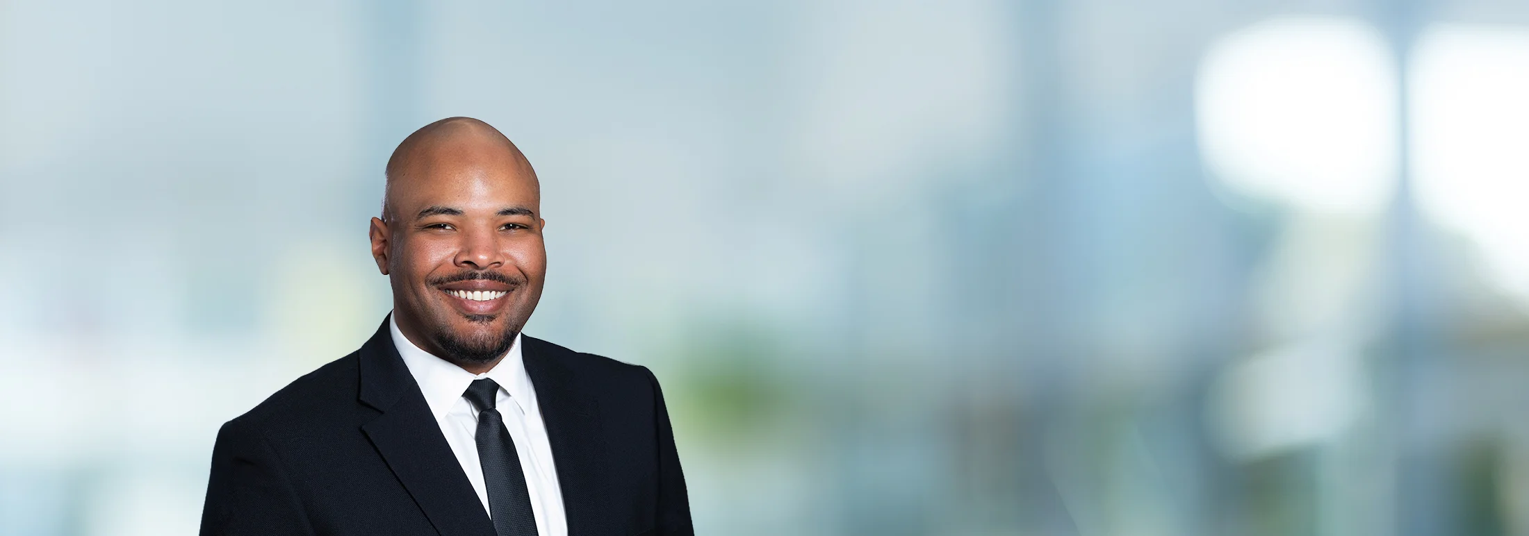 A photo of attorney McKinley Reynolds against a softly blurred office background