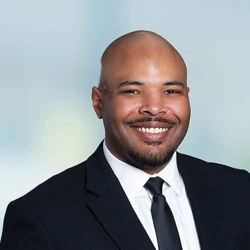 A photo of attorney McKinley Reynolds against a softly blurred office background