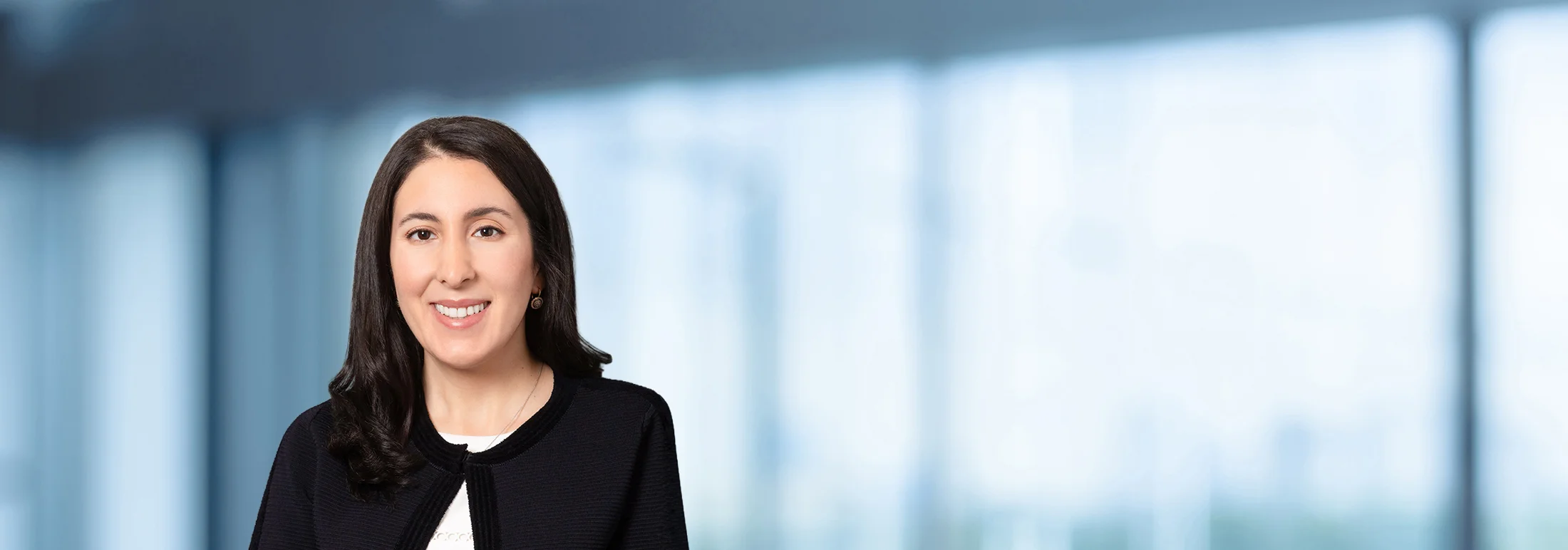 A photo of attorney Tiffany Rouhi against a softly blurred office background