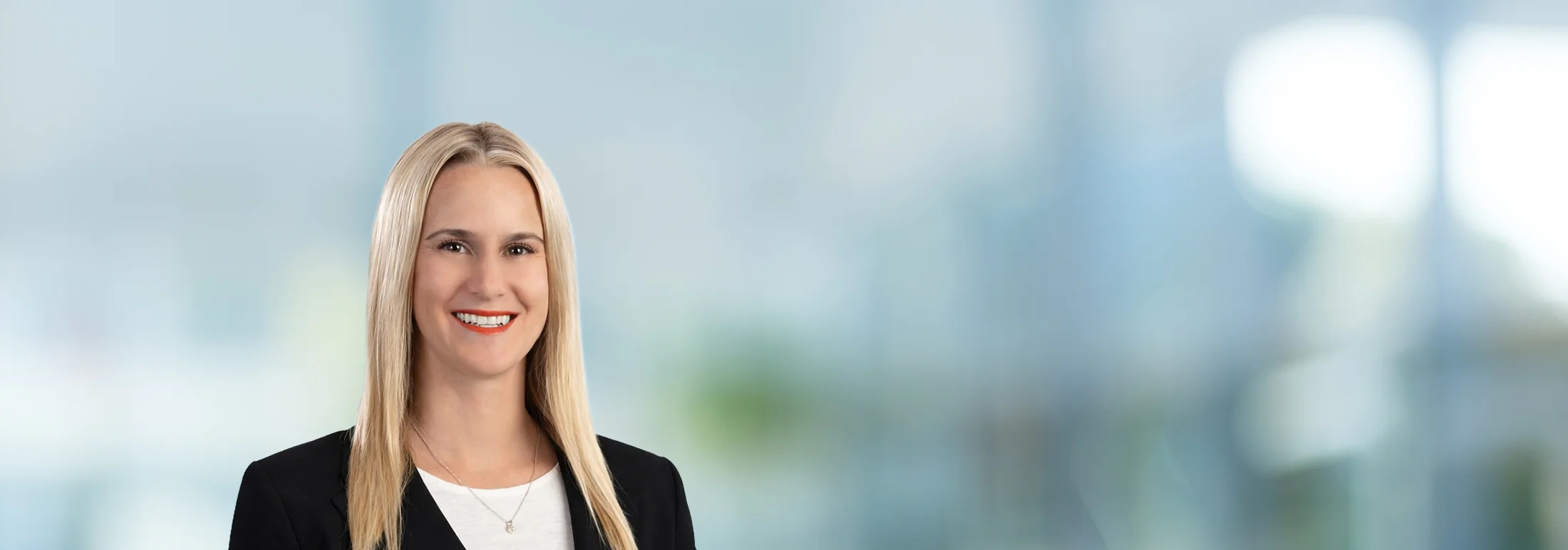A photo of attorney Kalli Sarkin against a softly blurred office background