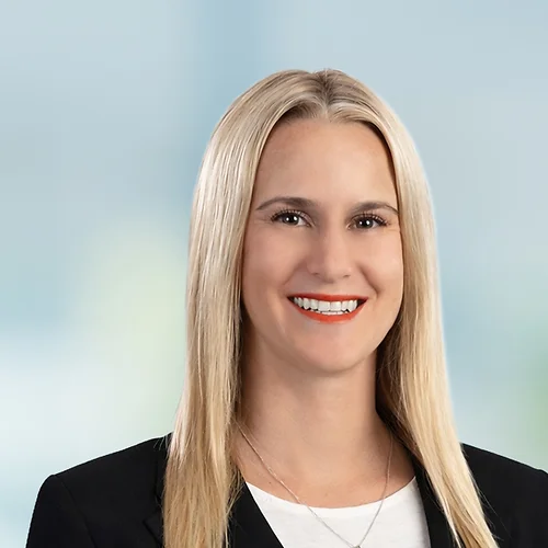 A photo of attorney Kalli Sarkin against a softly blurred office background