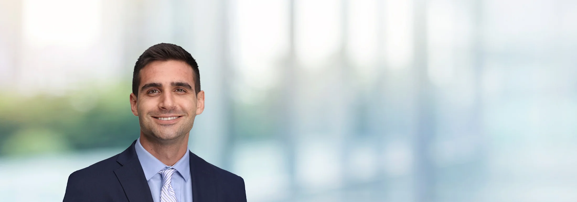 A photo of attorney Spyros Staikos against a softly blurred office background