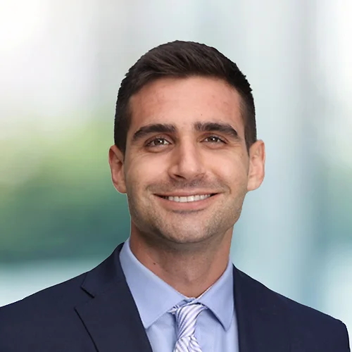 A photo of attorney Spyros Staikos against a softly blurred office background