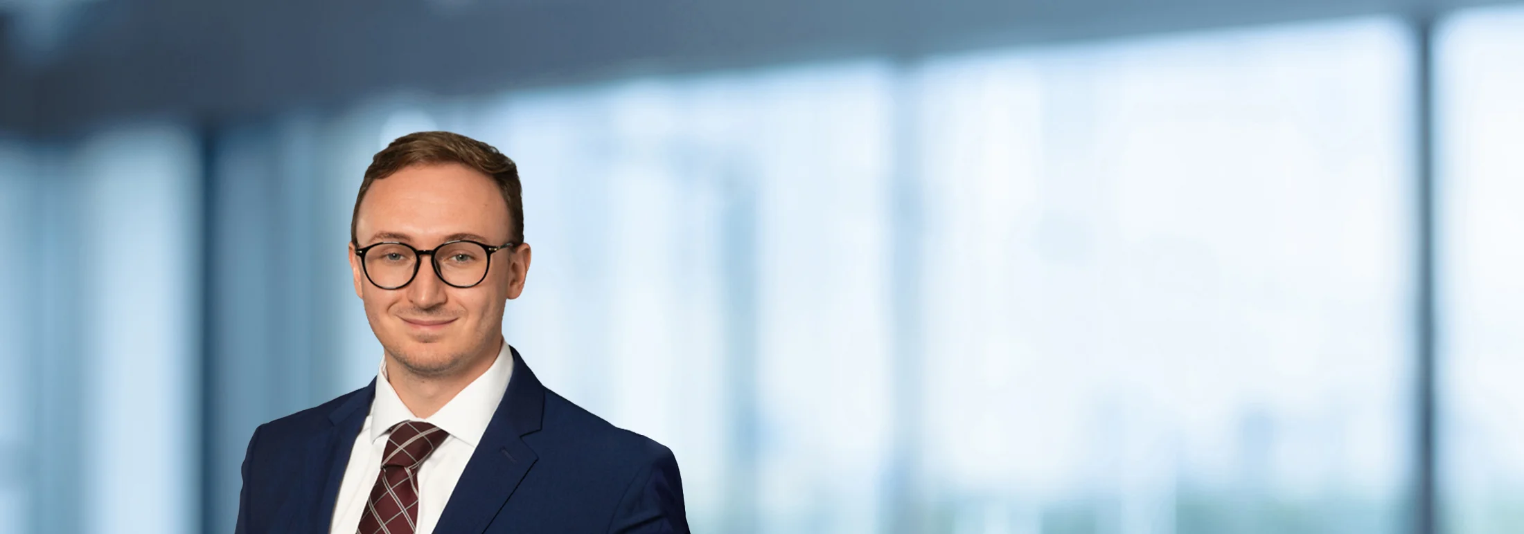 A photo of attorney Kyle Thompson against a softly blurred office background
