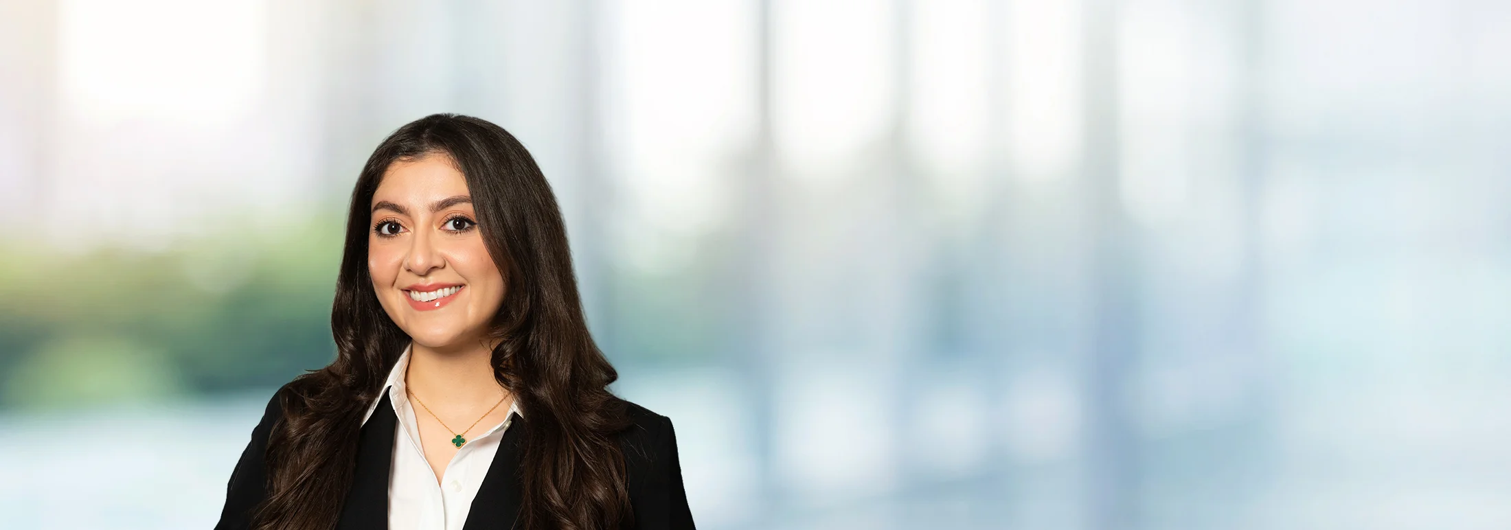 A photo of attorney Melanie Topchyan against a softly blurred office background