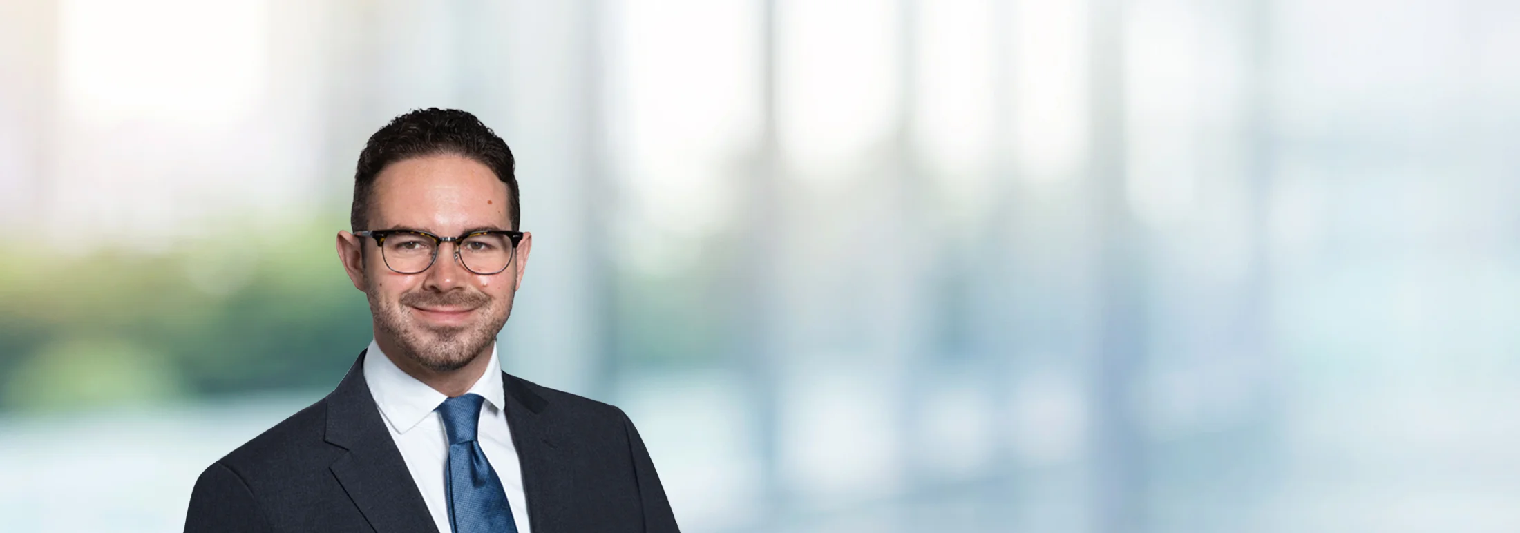 A photo of attorney Christopher Weinberger against a softly blurred office background