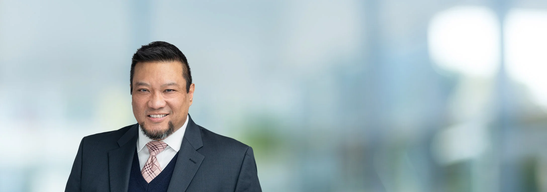 A photo of attorney Oscar Jimenez against a softly blurred office background