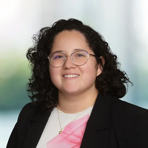 A photo of attorney Mizeille Avina against a softly blurred office background