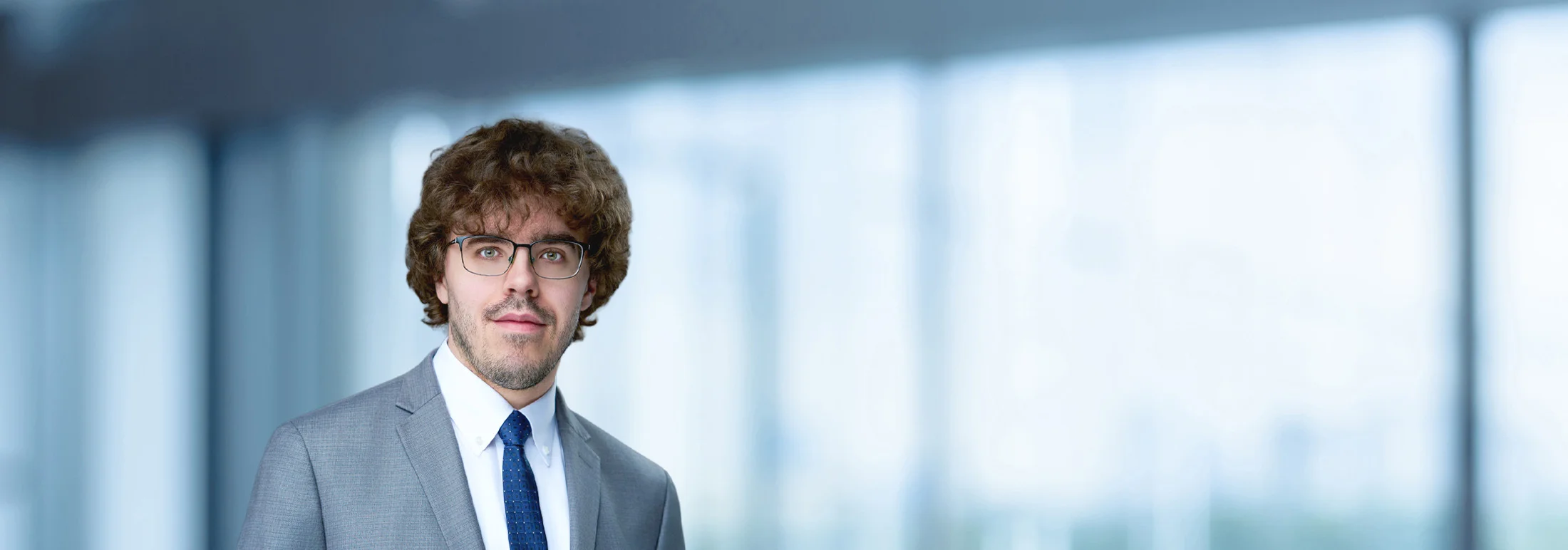 A photo of attorney Dale Wolf against a softly blurred office background