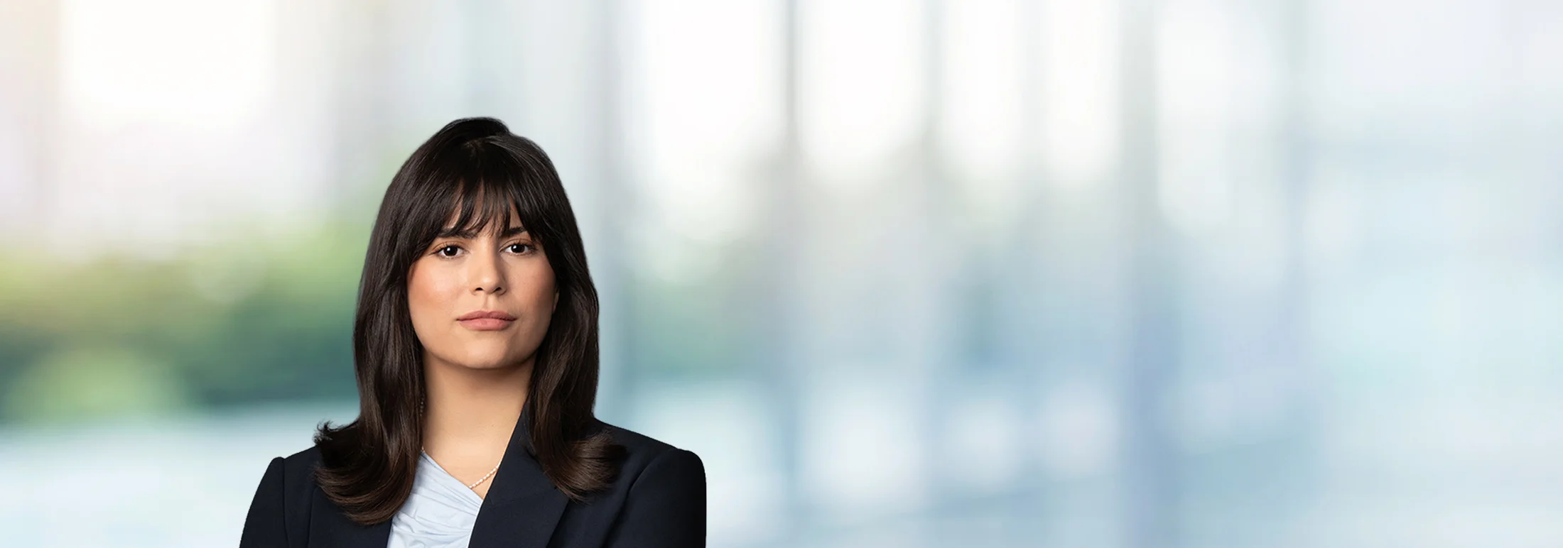 A photo of attorney Juliana Guillen against a softly blurred office background