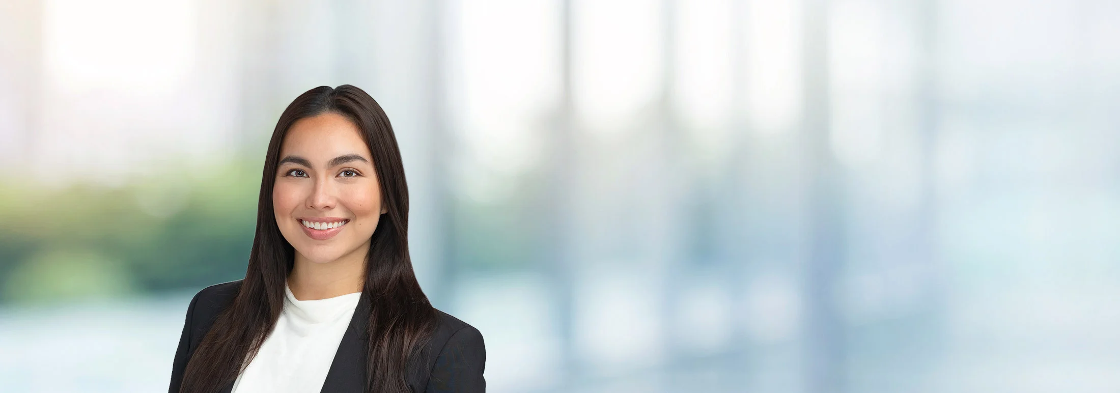 A photo of attorney Cresencia Meno against a softly blurred office background