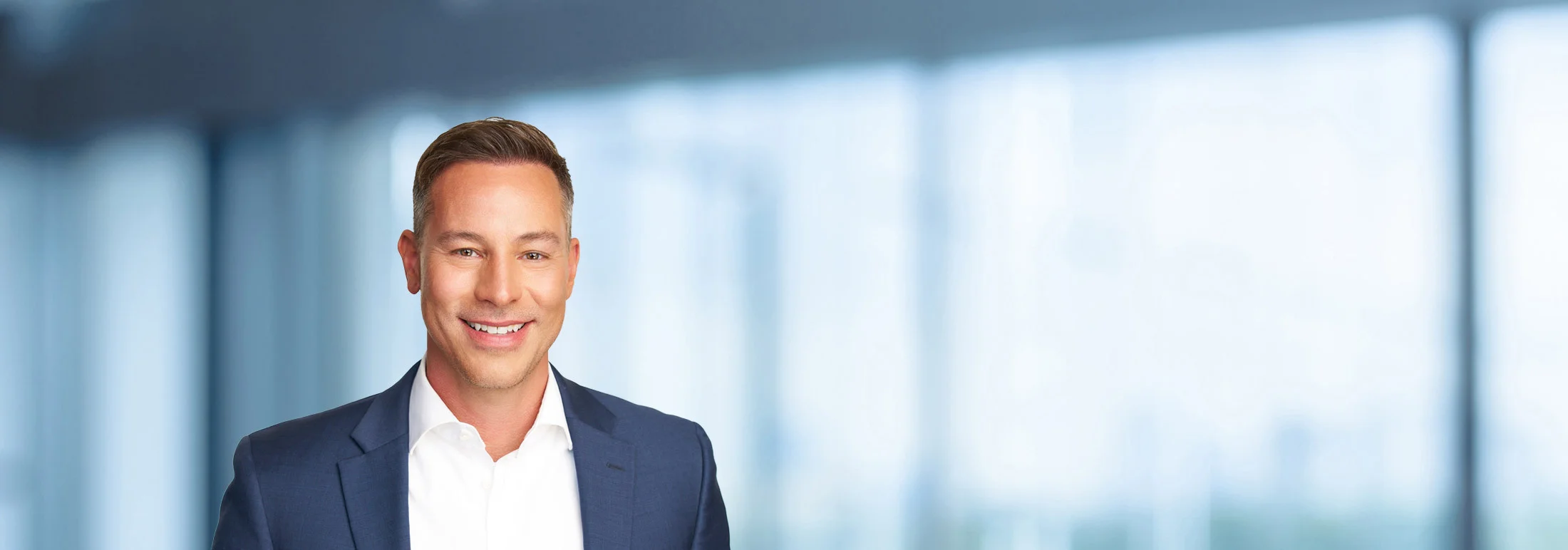 A photo of attorney Ryan Evans against a softly blurred office background