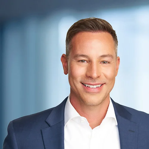 A photo of attorney Ryan Evans against a softly blurred office background