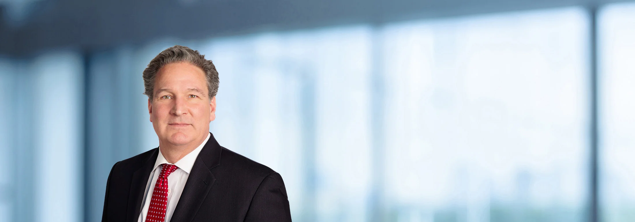 A photo of attorney Tom Grant against a softly blurred office background