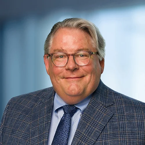 A photo of attorney, Mike Barnsback, against a softly blurred office background.