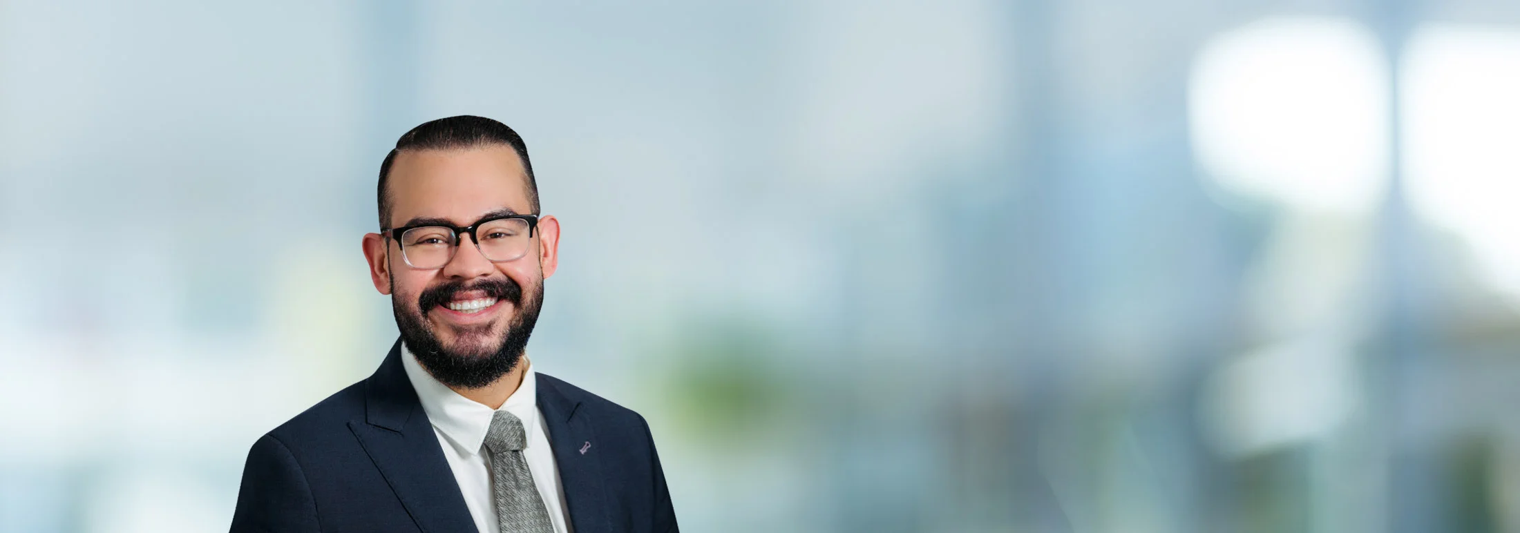 A photo of attorney Daniel Trujillo against a softly blurred office background