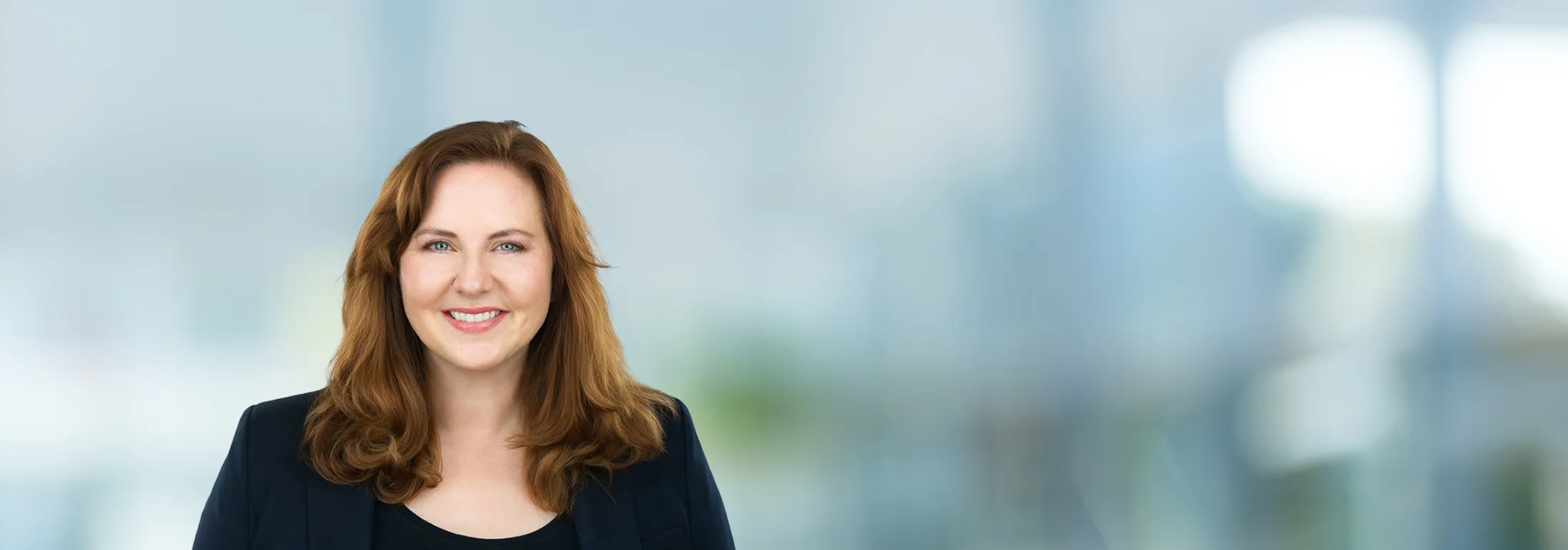 A photo of attorney, Amy Heerink, against a softly blurred office background.