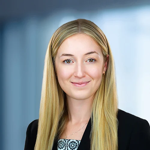 A photo of attorney, Emily Hurley, against a softly blurred office background.