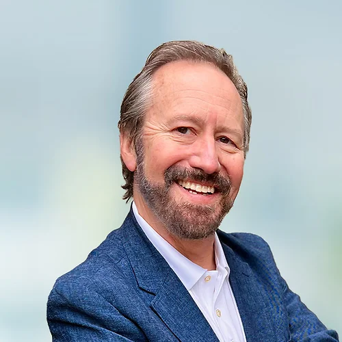 A photo of attorney Kenneth Smith against a softly blurred office background