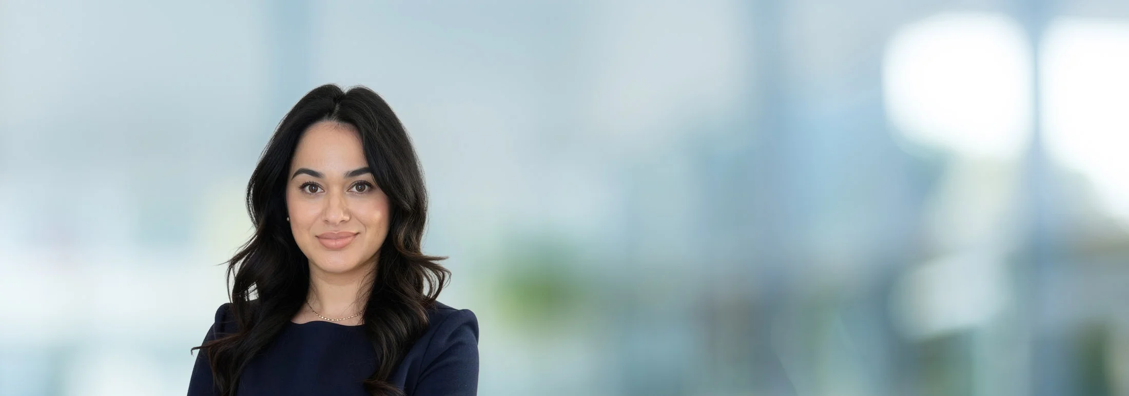 A photo of attorney Heidy Flores against a softly blurred office background