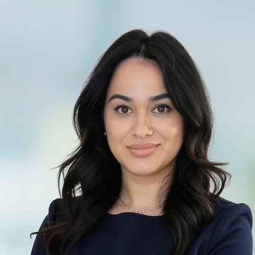 A photo of attorney Heidy Flores against a softly blurred office background