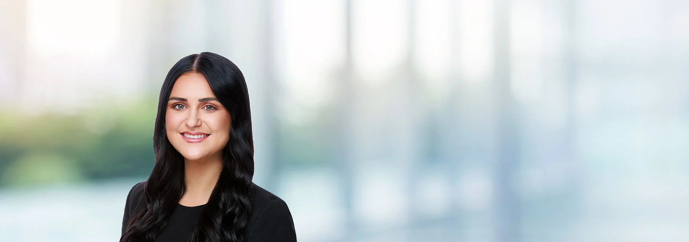 A photo of attorney Rachael McMillen against a softly blurred office background