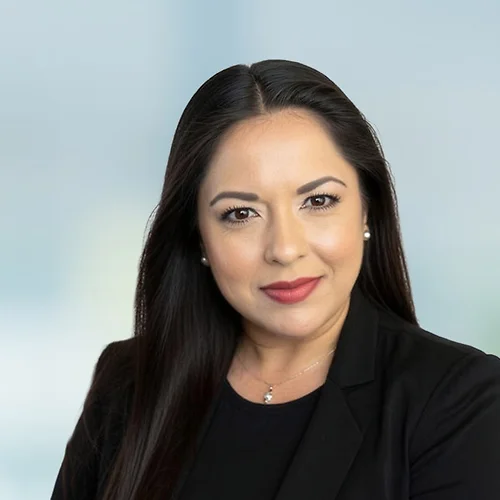A photo of attorney Joana Brooker against a softly blurred office background.