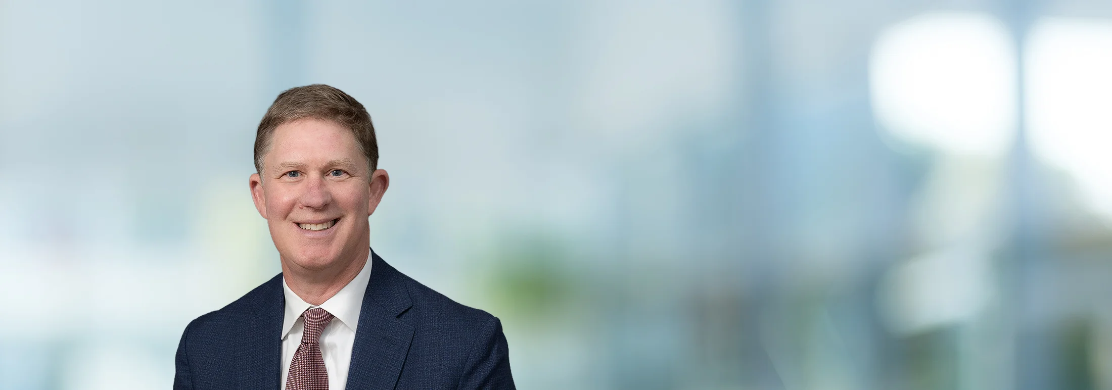 A photo of attorney, Mark Nevils, against a softly blurred office background.