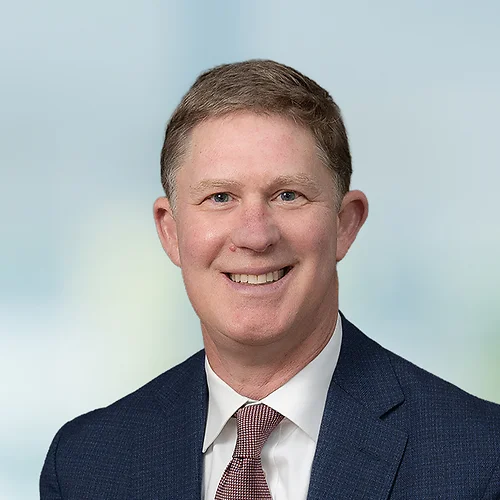 A photo of attorney, Mark Nevils, against a softly blurred office background.