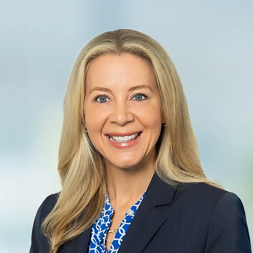 A photo of attorney, Katherine Akamine, against a softly blurred office background