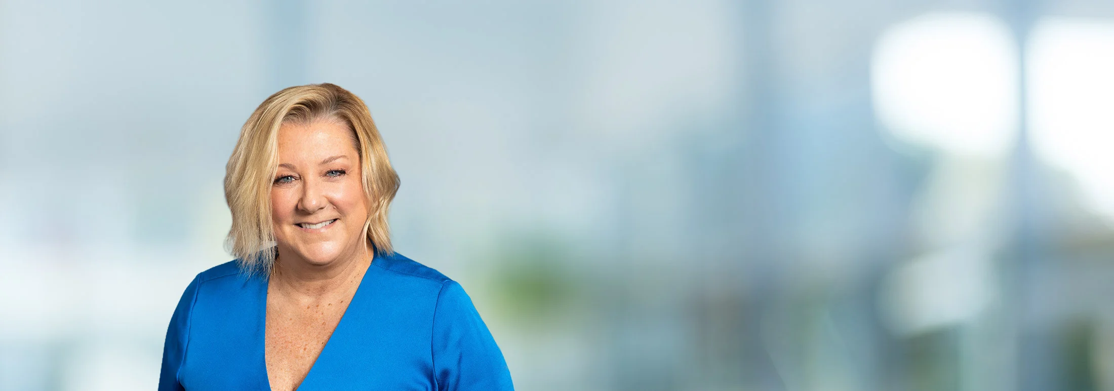 A photo of attorney Jessica Hahn against a softly blurred office background.