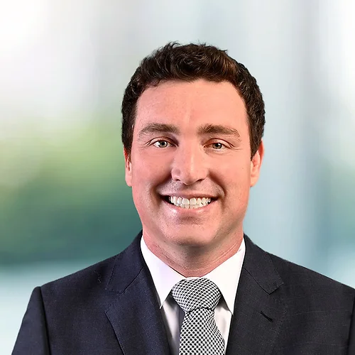 A photo of attorney Ryan Benson against a softly blurred office background