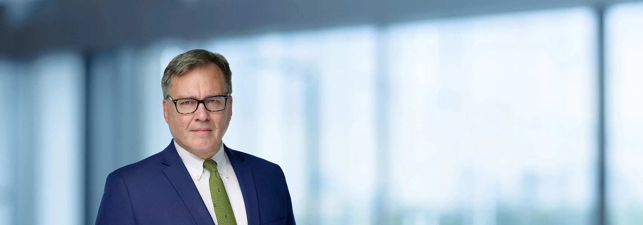 A photo of attorney Scott Oostdyk against a softly blurred office background