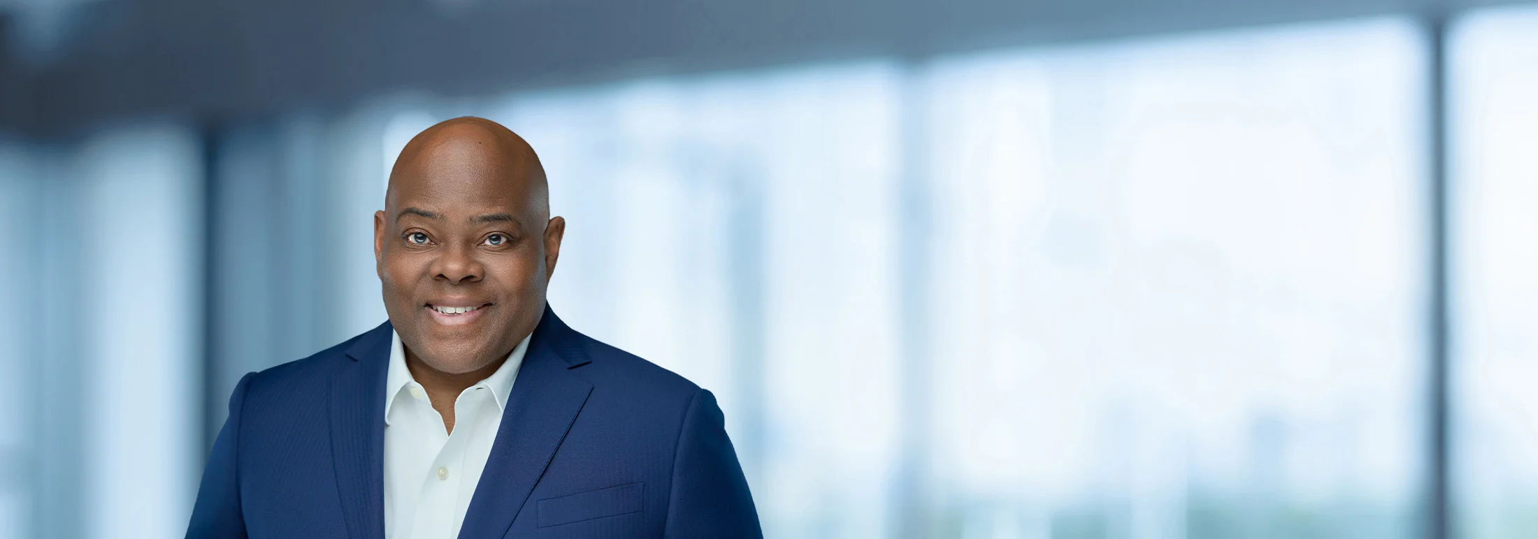 A photo of attorney Kelvin Newsome against a softly blurred office background.
