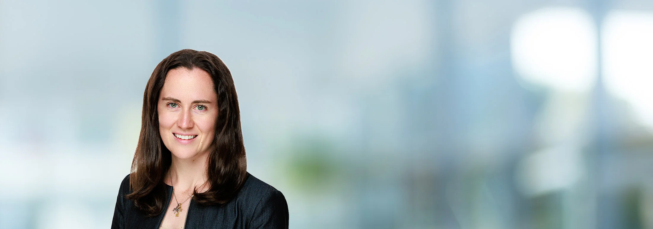 A photo of attorney Jacqueline McDonnell against a softly blurred office background