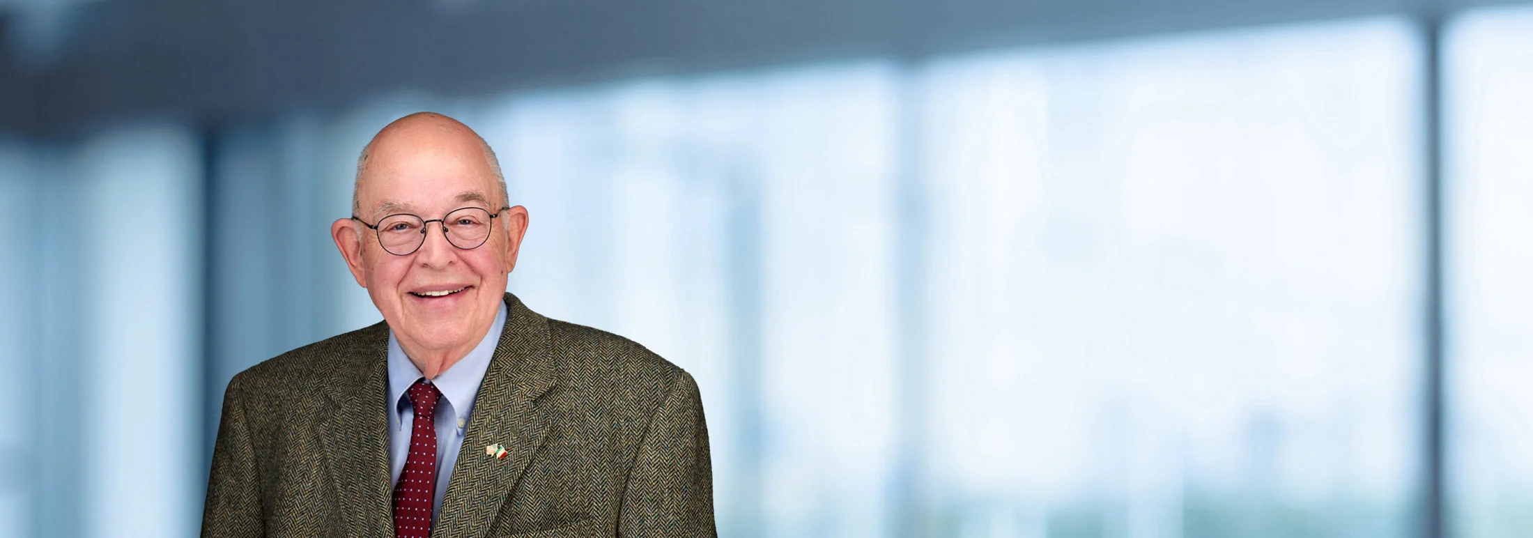 A photo of attorney John Purdy against a softly blurred office background