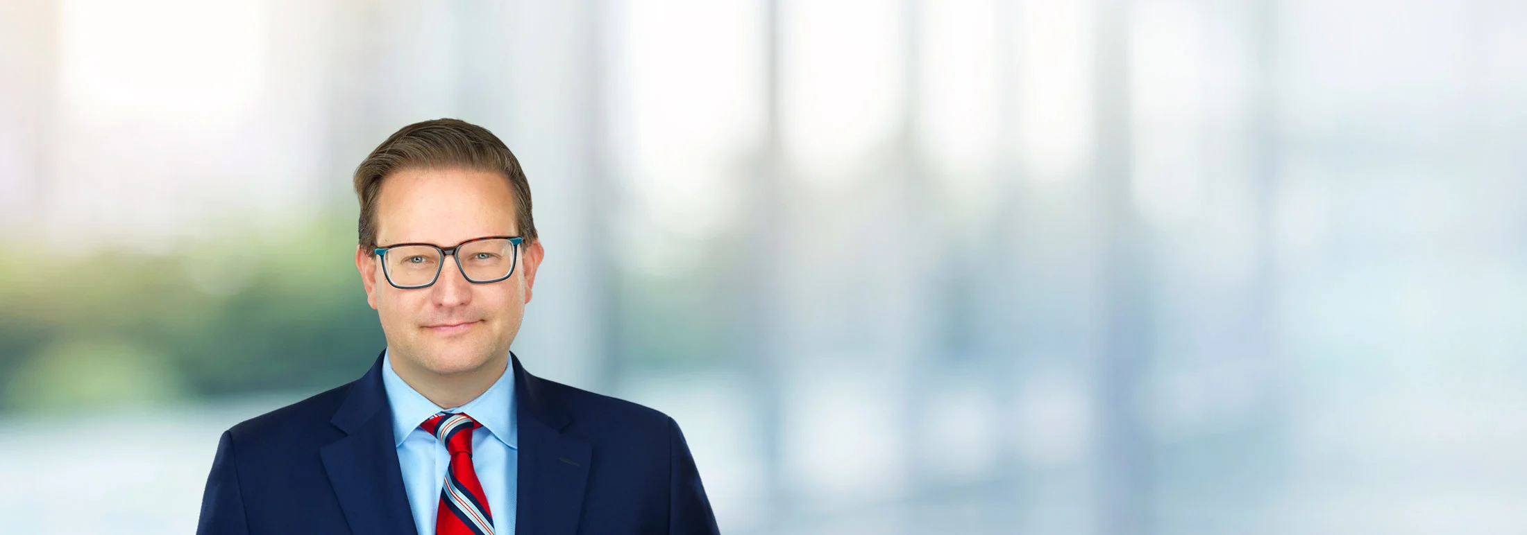 A photo of attorney Brian Stolarz against a softly blurred office background