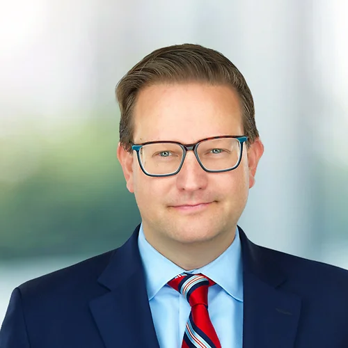 A photo of attorney Brian Stolarz against a softly blurred office background